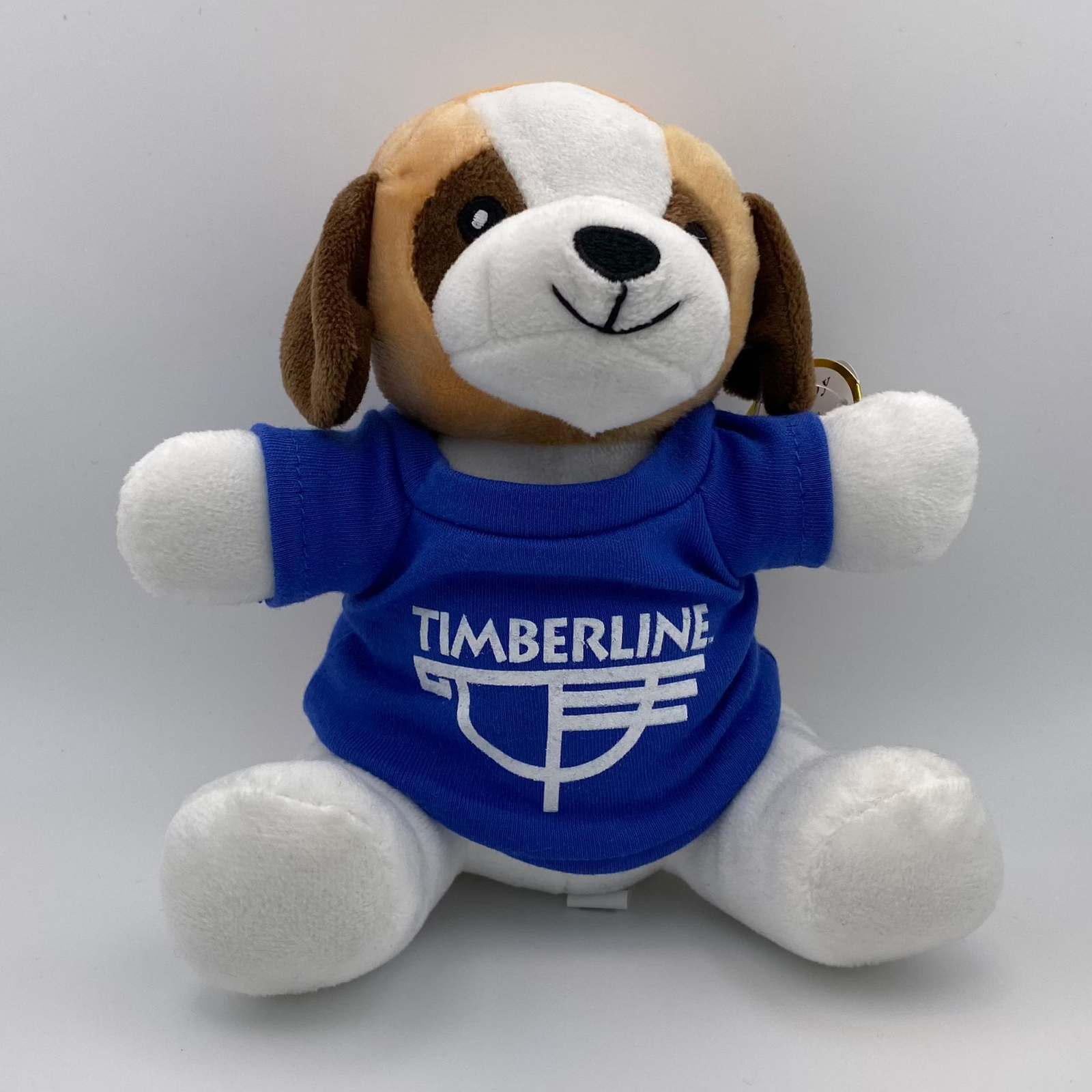 Plush dog toy with a blue shirt featuring 'Timberline' on a white background