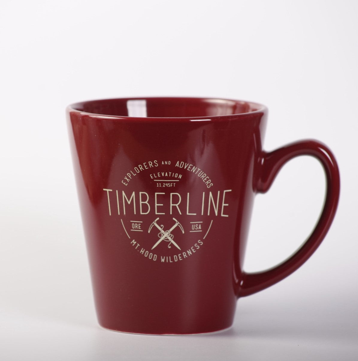 Red mug with 'Timberline' branding on a white background