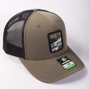 Brown and black trucker cap with a patch on a white background
